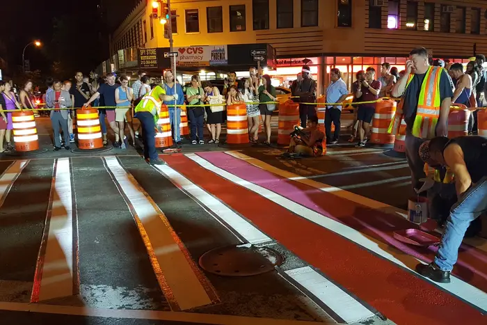 Members of New York City’s Department of Transportation paint the crosswalk outside of Stonewall Inn with the colors of the pride flag in honor of pride week on June 25, 2017 (NYC Department of Transportation)